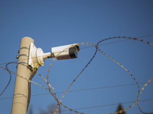 security camera on barbed wire fence